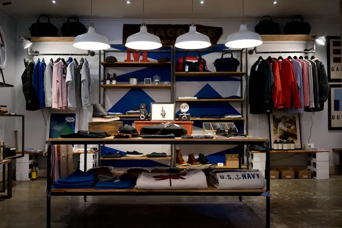 Clothing store with apparel racks and merchandise display tables