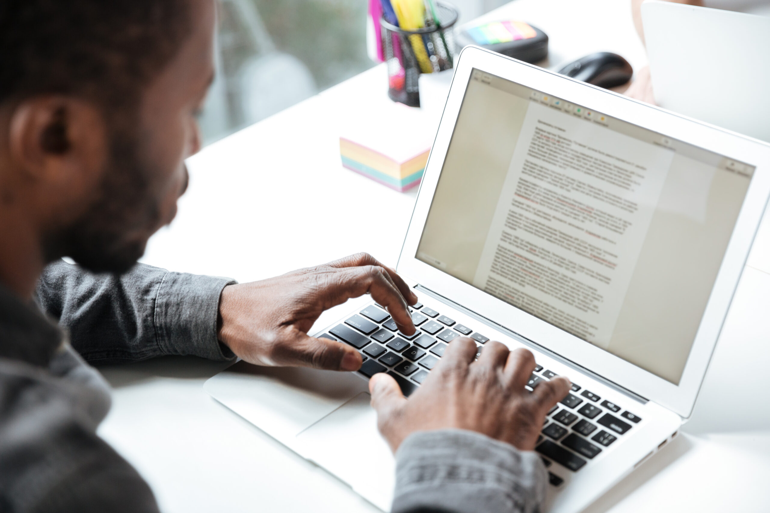Cropped photo of serious young man sitting in office coworking | UpRango SEO Content Writing Services